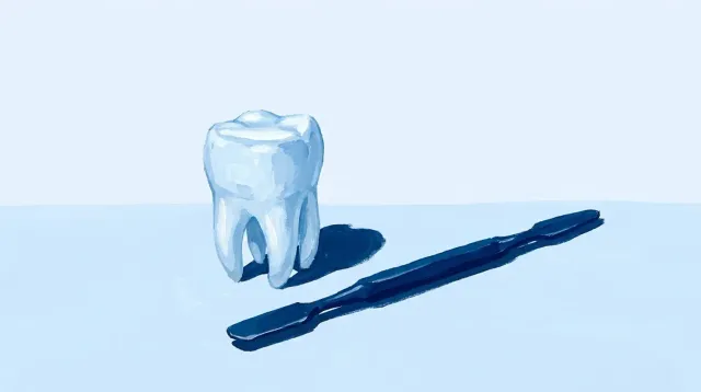 Un molar reconstruido con composite junto a la espátula con la que se modela