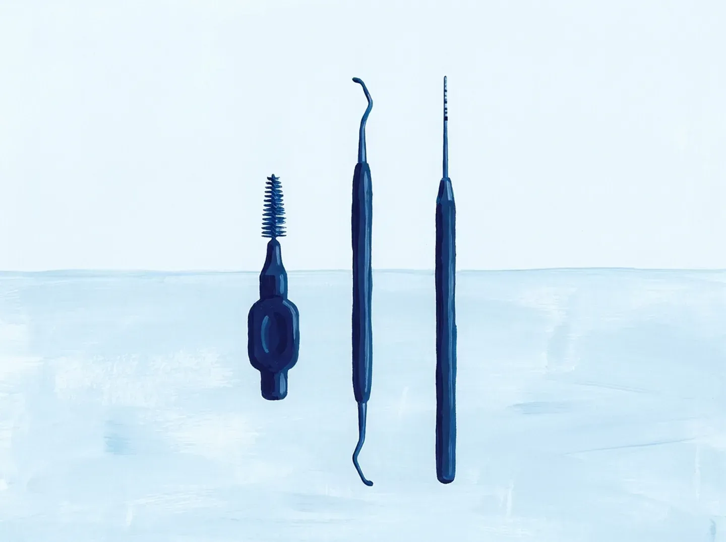 Un cepillo interdental, una cureta y una sonda periodontal en fila sobre la mesa